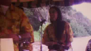 Hawaii USA (1962): Woman Singing At Outdoor Concert While Playing A Ukulele