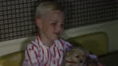 Seaside New Jersey USA (1949): Young Boy Sits At Table While A Small Yellow Lab