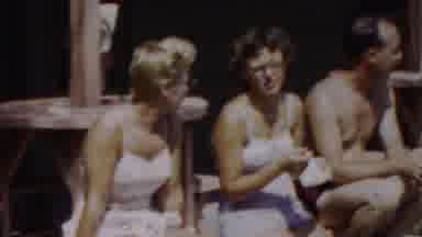 Seaside New Jersey USA (1949): Two Women And A Men Are Sitting On A Bench Wearing