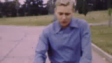San Diego California USA (1955): White Man Walking Down Street Talking And Baby