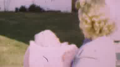 San Diego California USA (1955): Young Parents Enjoying Time With Their Child On A