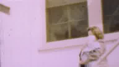 San Diego California USA (1955): Lady Carrying Infant Down Stairs