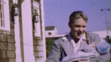 San Diego California USA (1955): Man Carrying Baby Smiling And Talking