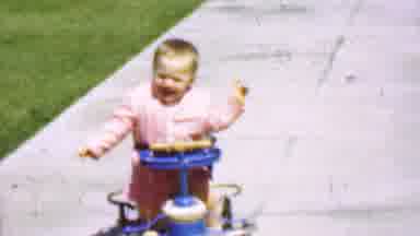 San Diego California USA (1955): Young Child Learning To Walk In Walker Rolling