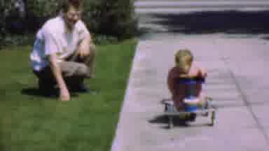 San Diego California USA (1955): The Kid Is Learning To Ride His Vehicle And They