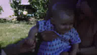 San Diego California USA (1955): Two People Holding A Baby Who Is Squirming