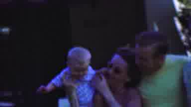 San Diego California USA (1955): A Woman In Sunglasses Is Holding A Baby While A