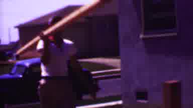 Phoenix Arizona USA (1956): People Sitting Outside While A Man Carries A Pole