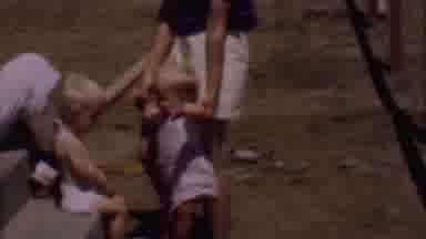 PHOENIX ARIZONA USA-1956: Toddler Playing Near Door With Woman In Red Shirt