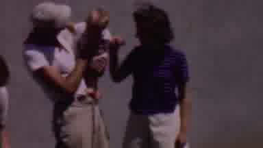 Phoenix Arizona USA (1956): A Father Is Holding His Child While The Mother Plays