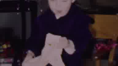 Phoenix Arizona USA (1956): Child Unfolds A Cloth Bag