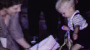 Phoenix Arizona USA (1956): Woman Help Boy Unwrap Present Floor Sosmeone Watches