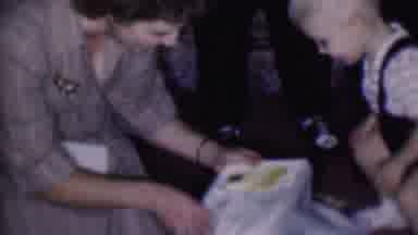 Phoenix Arizona USA (1956): Woman Helps Child Open And Repackage Gifts