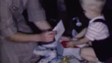 Phoenix Arizona USA (1956): Boy Opens Gifts On Christmas Morning