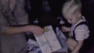 Phoenix Arizona USA (1956): Happy Child Gets Help Opening Gifts From Adults