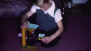 Phoenix Arizona USA-1956: Young Boy Playing With Toy On Floor, Woman Watching
