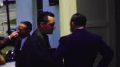 Dallas Texas USA (1956): Men And Women Dressed Up Conversing Outside Building