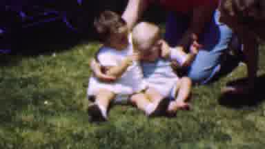 Dallas Texas USA (1956): Two Adults Playing With Two Babies Outside On The Grass