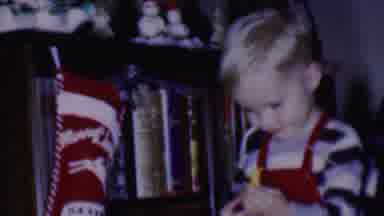 Phoenix Arizona USA (1956): Little Boy Opening Up Gifts Makes Him Smile