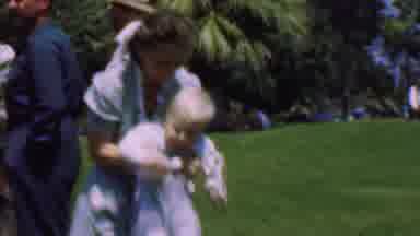 Dallas Texas USA (1956): A Woman Sets Down A Little Boy Who Is Holding A Dandelion