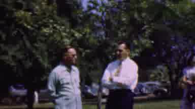 Dallas Texas USA (1956): Men Talking Outside