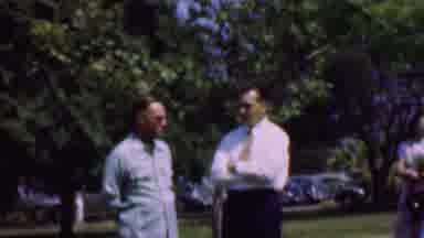 Dallas Texas USA (1956): Two Men Standing Outside Talking