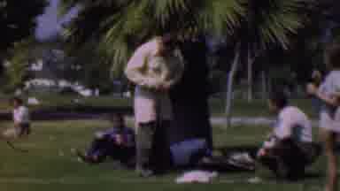 Dallas Texas USA (1956): Man Putting On Coat Under A Palm Tree