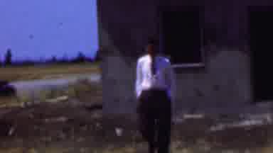 Dallas Texas USA (1956): A Man In A Suit Walking Out Of A Desolate Building