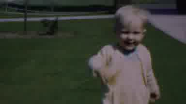 Dallas Texas USA (1956): Toddler Girl Dressed In Yellow Walking On Grass Next To A