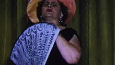 Dallas Texas USA (1956): A Woman Unfurling A Fan Is Singing