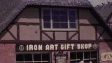 Solvang California USA (1955): Female Artist Leaving Iron Art Gift Shop Parking