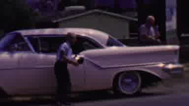 Solvang California USA (1955): Kid Acting Happy Leaning On White Car With Older