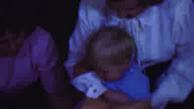 Terra Haute Indiana USA (1963): Two People And A Kid One Adult Is Putting A Child