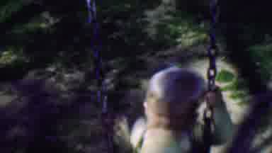Terra Haute Indiana USA (1963): A Blonde Male Toddler Plays On A Swing Set