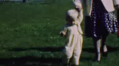 Terra Haute Indiana USA (1963): Child Being Walked Across A Grassy Lawn
