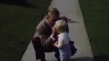 Terra Haute Indiana USA (1963): Older Man Blows A Whistle As A Little Boy Walks
