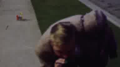 Terra Haute Indiana USA (1963): Man Bending Down To Toddler Who Has A Small Toy In