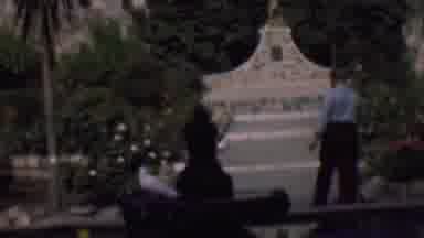 San Diego California USA-1961: Man Walking Toward Bird Bath in Garden