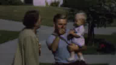 San Diego California USA (1961): A Man Holding A Child And A Woman Pushing The
