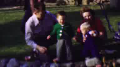 San Diego California USA (1961): Man And Woman With Child Sit Down With Other