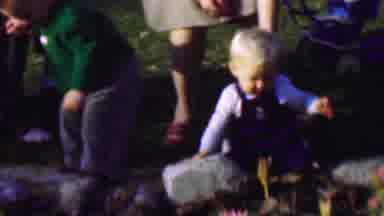 San Diego California USA (1961): A Woman Holding A Little Boy While He Plays In