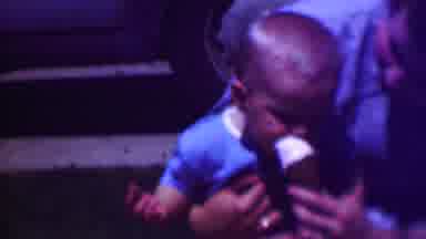 San Diego California USA (1961): Child Sitting On Mans Lap Eating Ice Cream