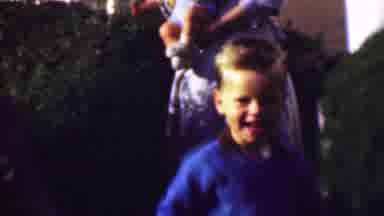 San Diego California USA-1961: Young Boy Smiling in Garden with Family