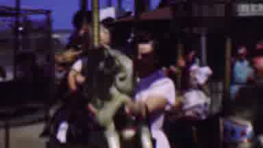 Terra Haute Indiana USA (1963): A Baby On A Carousel Horse With Woman Whose Arms