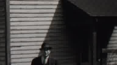Beachwood New Jersey USA (1937): Man Dressed In Suit Walking Up A Small Hill Away
