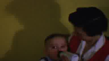 Des Moines Iowa USA (1959): Woman On Chair Bottle Feeding Dark Haired Baby While