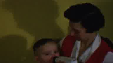 Des Moines Iowa USA (1959): Happy Mom Feeding Her Baby A Bottle.