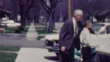 Grand Rapids Michigan USA (1958): A Man Surprises A Young Boy With A Hug From