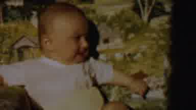 Lincoln Nebraska USA (1962): Baby Whimpers As It Sits And Reaches Downward On A