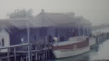 Louisiana USA-1959: A Boat Docked At A Wooden Pier Near Boathouses